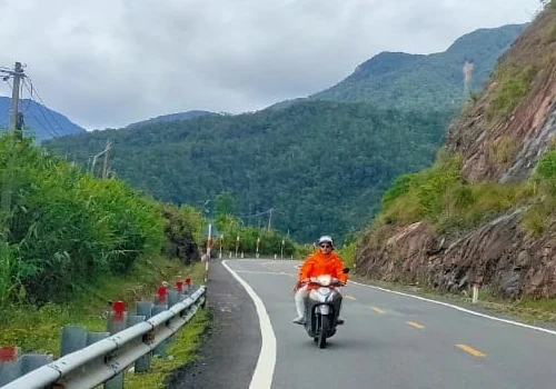 A person riding a motorbike through the mountains between Dalat and Nha Trang.